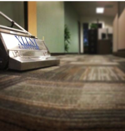 XLLNT Carpet Care branded equipment cleaning an office carpet